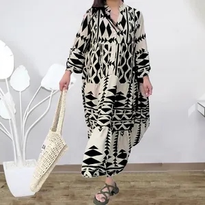 Detail view of bohemian maxi dress with black and white geometric print and tiered skirt