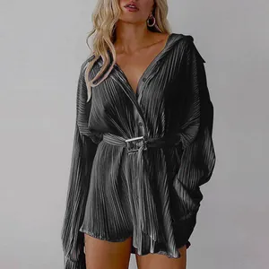 Detail of black pleated long-sleeve shirt dress with a waist belt