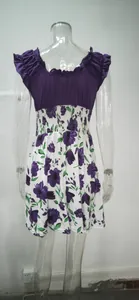 Detailed back view of an elegant summer dress with purple floral print and elastic waist