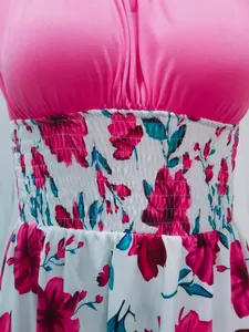 Close-up detail of an elegant floral print dress featuring a smocked waist and pink bodice