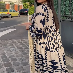 Elegant bohemian long-sleeved maxi dress featuring a chic black geometric print design.