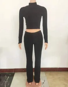 Close-up detail of a women's black slim fit knit set featuring a crop top and wide-leg pants.