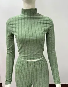 Detail of green ribbed knit two-piece set with long-sleeved turtleneck crop top