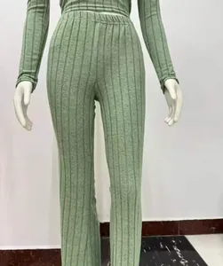 Close-up detail of the green ribbed knit texture on the crop top and wide-leg pants set.