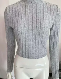 Detailed view of grey ribbed knit cropped sweater top on mannequin showing slim fit texture