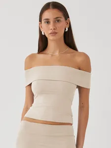 Specific view of the off-the-shoulder design and body-hugging fit of the beige summer top.