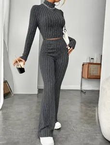 Slim fit charcoal grey ribbed knit two-piece set with crop top and flared pants.