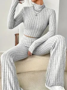 Chic grey ribbed knit two-piece set featuring long sleeve crop top and flare pants