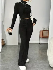 Detailed view of a black ribbed knit two-piece set with a crop top and flared pants.