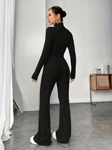 Back view of a slim fit black ribbed knit two-piece set with long sleeve top and flare pants