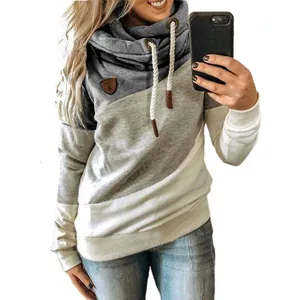 Close-up of color-block cowl neck hoodie with drawstring and leather patch detail