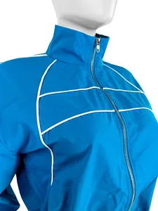 Close-up of a blue athletic jacket with white piping details and a silver zipper.