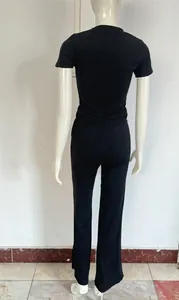 Vue arrière d'un ensemble deux pièces noir avec haut à manches courtes et pantalon long.