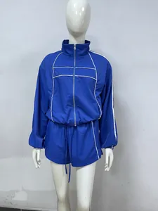 Royal blue two-piece sports tracksuit set featuring white contrast piping and a zip-up jacket