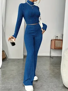 Full-body view of blue ribbed knit set with cropped mock neck top and pants.