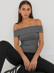 Close-up detail view of grey off-the-shoulder top featuring a slim fit and soft fabric texture