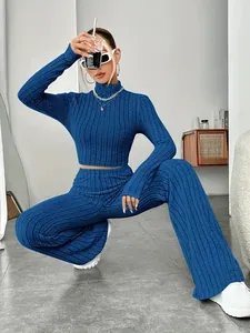 Blue ribbed knit two-piece set featuring long sleeve crop top and wide-leg trousers
