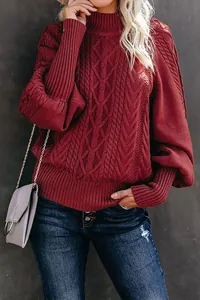 Close-up detail of burgundy cable-knit sweater with elegant oversized lantern sleeves