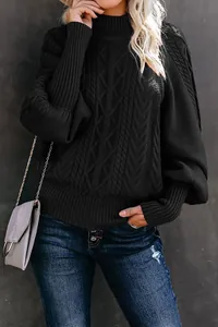 Close-up of black cable knit sweater featuring elegant lantern sleeves and chunky texture.