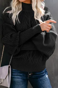 Close-up detail of black cable knit sweater featuring elegant lantern sleeve texture