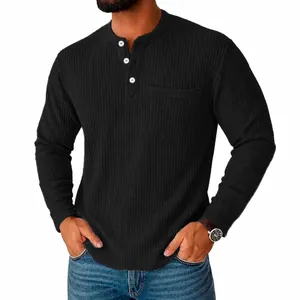 Close-up of black waffle knit Henley shirt with three buttons and pocket