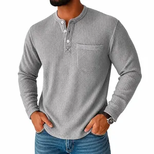 Detailed view of men's grey waffle-knit Henley shirt with button neck and chest pocket
