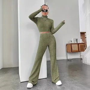 Olive green ribbed knit two-piece set featuring a cropped top and flared pants.