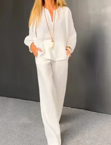 White cotton linen two-piece casual set featuring V-neck top and straight-leg pants.
