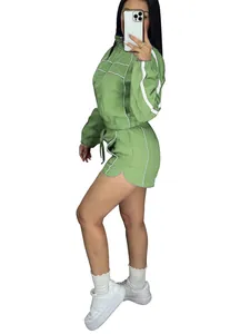 Detailed full-body view of a green two-piece sports shorts set with white piping