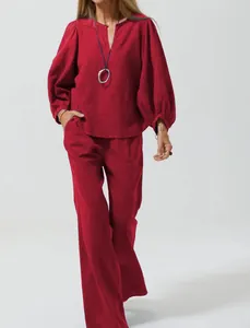 Red cotton linen two-piece set with puff sleeves and wide-leg trousers detail view.