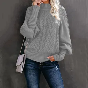 Detail of a grey cable knit lantern sleeve sweater with elegant loose fit design