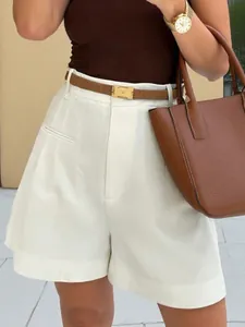 Detail view of high-waisted white wide-leg shorts with a structured and elegant A-line fit