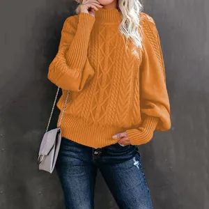 Detail shot of elegant orange cable knit sweater featuring stylish loose lantern sleeves