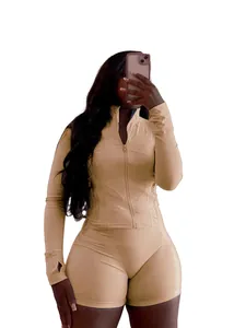Ensemble de yoga beige pour femmes avec veste zippée à manches longues et short moulant.