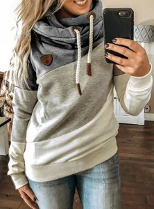 Detail of color-block cowl neck hoodie with drawstring and leather patch