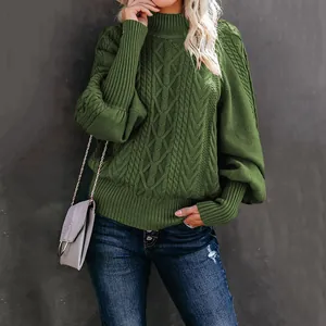 Detail showing the elegant dark green cable-knit sweater with stylish lantern sleeves