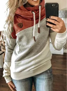 Close-up detail of women's cowl neck hoodie with three-color blocked patchwork design