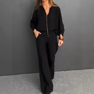Elegant black cotton linen two-piece set featuring a v-neck top and wide-leg trousers.