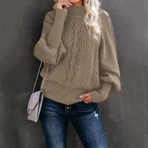Detailed view of khaki cable-knit sweater with elegant lantern sleeves and high neck.