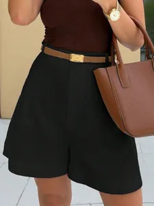 Detail of women's high-waisted black wide-leg shorts with a professional outfit