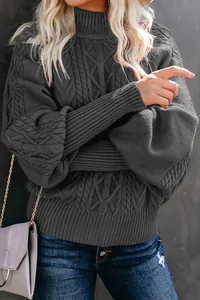 Detailed texture of dark grey cable knit sweater with loose lantern sleeves for winter