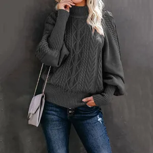 Close-up view of a grey cable knit sweater featuring elegant oversized lantern sleeves