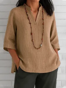 Close-up of women's V-neck cotton linen shirt with three-quarter sleeves in earthy brown