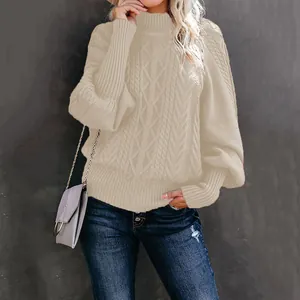 Detailed view of an elegant beige cable knit sweater with stylish lantern sleeves