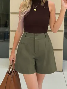 Outdoor street style view of high-waisted wide-leg olive green shorts for women