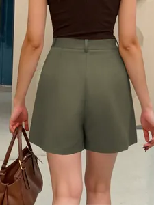 Back view showing the fit and detail of army green high-waisted A-line shorts for women