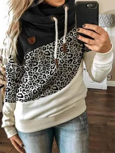 Close-up of women's cowl neck sweatshirt with leopard print and color block design
