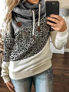 Close-up of women's cowl neck sweatshirt featuring leopard print and grey-white color blocking