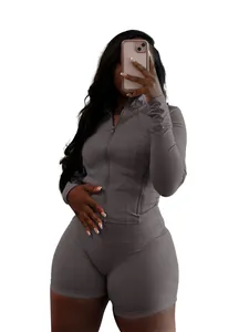 Grey two-piece sports yoga set with zip-up jacket and tight shorts for women