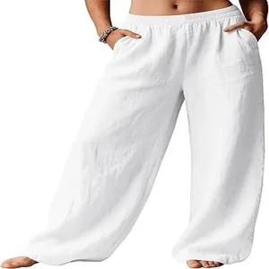 Detail view of white linen wide-leg trousers showing the fabric texture and side pockets